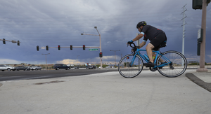 Bicyclist on the Western Beltway Trail at West Sahara Avenue interchange, Las Vegas, Nevada: digital photograph