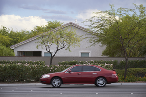 A home, traffic, and landscaping along West Sahara Avenue near Pavilion Center Drive, Las Vegas, Nevada: digital photograph