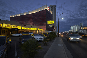 The Golden Steer restaurant dwarfed by the Lucky Dragon hotel and casino and The Allure residential tower looking east at dusk, Las Vegas, Nevada: digital photograph