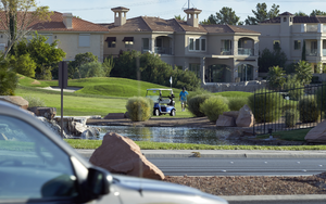 Golfer at Canyon Gate with traffic on West Sahara Avenue, Las Vegas, Nevada: digital photograph