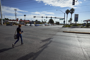 Pedestrian crosses South Durango Drive at West Sahara Avenue, Las Vegas, Nevada: digital photograph