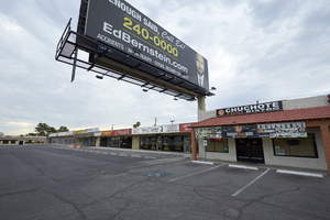 Billboard overshadows a strip mall on West Sahara Avenue looking southeast, Las Vegas, Nevada: digital photograph