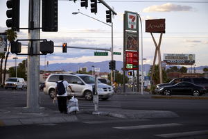 A pedestrain waiting to cross East Sahara Avenue at Maryland Parkway looking north at dusk, Las Vegas, Nevada: digital photograph