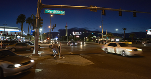 Pedestrian and auto traffic on East Sahara Avenue at Maryland Parkway looking west at night, Las Vegas, Nevada: digital photograph