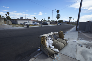 Old couch in neighborhood homes near East Sahara Avenue at Maryland Parkway, Las Vegas, Nevada: digital photograph