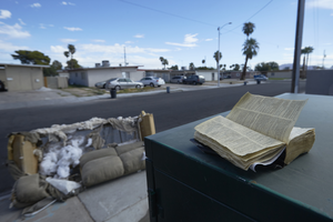 Weathered Bible and an old couch in neighborhood homes near East Sahara Avenue at Maryland Parkway, Las Vegas, Nevada: digital photograph