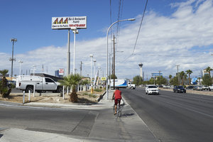 Bicyclist on East Sahara Avenue near Burnham Avenue looking west, Las Vegas, Nevada: digital photograph