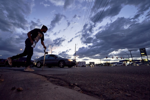 Skateboarder on East Sahara Avenue and Eastern Avenue looking west at sunset, Las Vegas, Nevada: digital photograph
