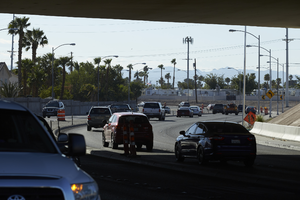 Traffic flows under the freeway overpass at East Sahara Avenue and Sandhill Road looking east, Las Vegas, Nevada: digital photograph