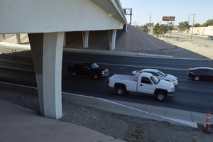 Traffic flows under the freeway overpass at East Sahara Avenue and Sandhill Road looking south, Las Vegas, Nevada: digital photograph