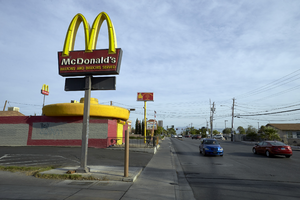 McDonald's sign next to the El Pollo Mobile restaurant on Arville Street, south of West Sahara Avenue, looking north, Las Vegas, Nevada: digital photograph