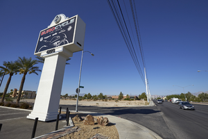 EuroCycle sign and vacant lot along West Sahara Avenue, looking west, Las Vegas, Nevada: digital photograph