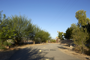 Path end behind single family housing at golf course, looking west, Las Vegas, Nevada: digital photograph