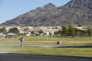 A worker at the Lewis Family Park, looking northeast, Las Vegas, Nevada: digital photograph