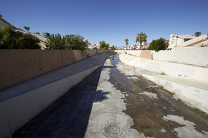 A flood control channel between houses off Tree Line Drive north of East Sahara Avenue, looking west, Las Vegas, Nevada: digital photograph