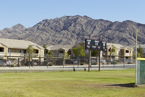Scoreboard at Las Vegas High School and apartments, looking northeast, Las Vegas, Nevada: digital photograph