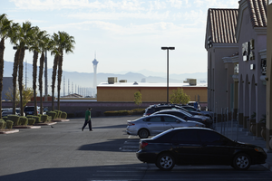Man walking in retail store parking lot off Cimarron Road south of West Sahara Avenue, looking east, Las Vegas, Nevada: digital photograph