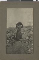 Unidentified person on dirt path: photographic print