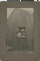 Two people posing in a window: photographic print