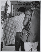Photograph of Jack Binion's Horseshoe Photograph Collection, 1940-1985. PH-00318. Special Collections &amp; Archives, University Libraries, University of Nevada, Las Vegas. Las Vegas, Nevada. posing for photos holding the million dollar display, Las Vegas (Nev.), circa 1971