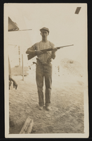 Unidentified man holding a rifle: photographic print