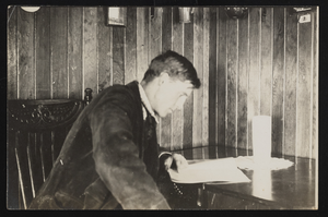Unidentified man at desk: photographic print