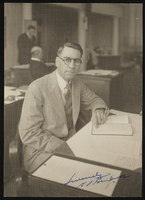 Autographed photograph of Albert S. Henderson seated at his desk in the Nevada State Legislature: photographic print