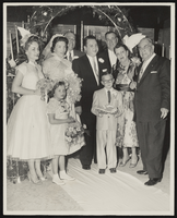 Albert S. Henderson (right) and Jack Entratter (back row, right) posing with the wedding party at a ceremony Henderson officiated: photographic print