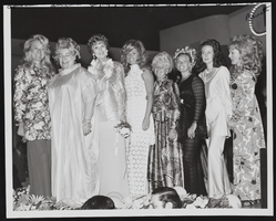 Lynn Claiborne, Linda Kramer, Judy Bayley, Joan Shoofey, Bonnie Gragson, Judy Silverman, Bea Farrell, and Mary Barnett (identified from left to right) at an unknown event: photographic print