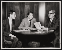 Larry duBoef (left) with two unidentified men reviewing an American Cancer Society report: photographic print