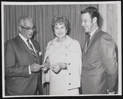 Judy Bayley with two unidentified men holding a donation check for the American Cancer Society: photographic print
