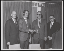 Four unidentified men holding a check for the American Cancer Society: photographic print