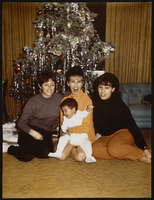 Michelle Daly (Marie's daughter), Marie McMillan holding her son Jeff McMillan, and Jeri McMillan (James B. McMillan's daughter) identified from left to right: photographic print