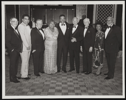 Grant Sawyer, Johnny West, Howard Cannon, an unidentified woman, Bob Bailey, Hank Greenspun, Oran Gragson, another unidentfied woman, and James B. McMillan identified from left to right: photographic print