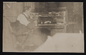 Frank Benham in his private office at the post office, Goldfield, Nevada: photographic print