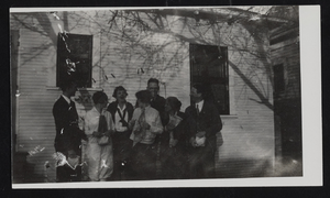 Unidentified group posing in from of a house: photographic print