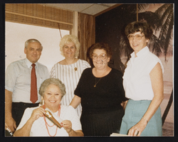 Alice Key (front), Rich Miller (left, back) and unidentified staff at an office birthday party: photographic print
