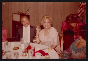 Alice Key and unidentified people at a dinner event: photographic print