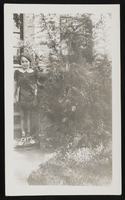 Young girl, possibly one of the Denton daughters, posed in front of house for the first day of school: photographic print