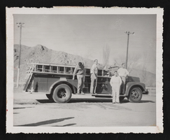 Larry Easton, Don Phillips, Jay Wilden, and Ronald Rose around fire truck in Caliente, Nevada (identified from left to right): photographic print