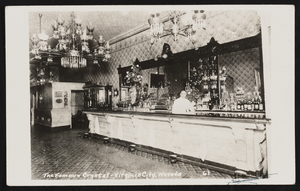 Interior of the Famous Crystal Bar with bartender behind bar in Virginia City, Nevada: postcard