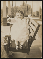 Nanelia Siegfried as a baby sitting on a swing: photographic print