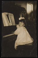 Nanelia Siegfried sitting at the piano: photographic print
