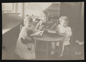 Nanelia, Victor and Victoria Siegfried around a table, Seattle, Washington: photographic print