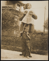 Seymour Kimball Bradford holding Victoria Siegfried, who is standing on Victor's shoulders: photographic print