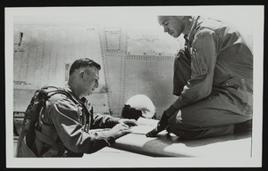 Howard Cannon signs a log after check out in F-86 aircraft: photographic print