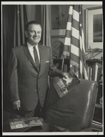 Howard Cannon posing in his office: photographic print