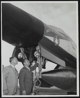 Howard Cannon explaines to Senator Stephen Young the landing lights used to illuminate the runway ahead of the United States Air Force's supersonic B-58 bomber, Las Vegas, Nevada: photographic print