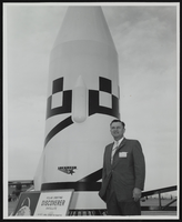 Howard Cannon posing next to a Discoverer Satellite at the World Congress of Flight, Las Vegas, Nevada: photographic print