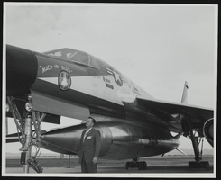Howard Cannon observes special features of the landing gear apparatus on the B-58 Hustler at the World Congress of Flight, Las Vegas, Nevada: photographic print